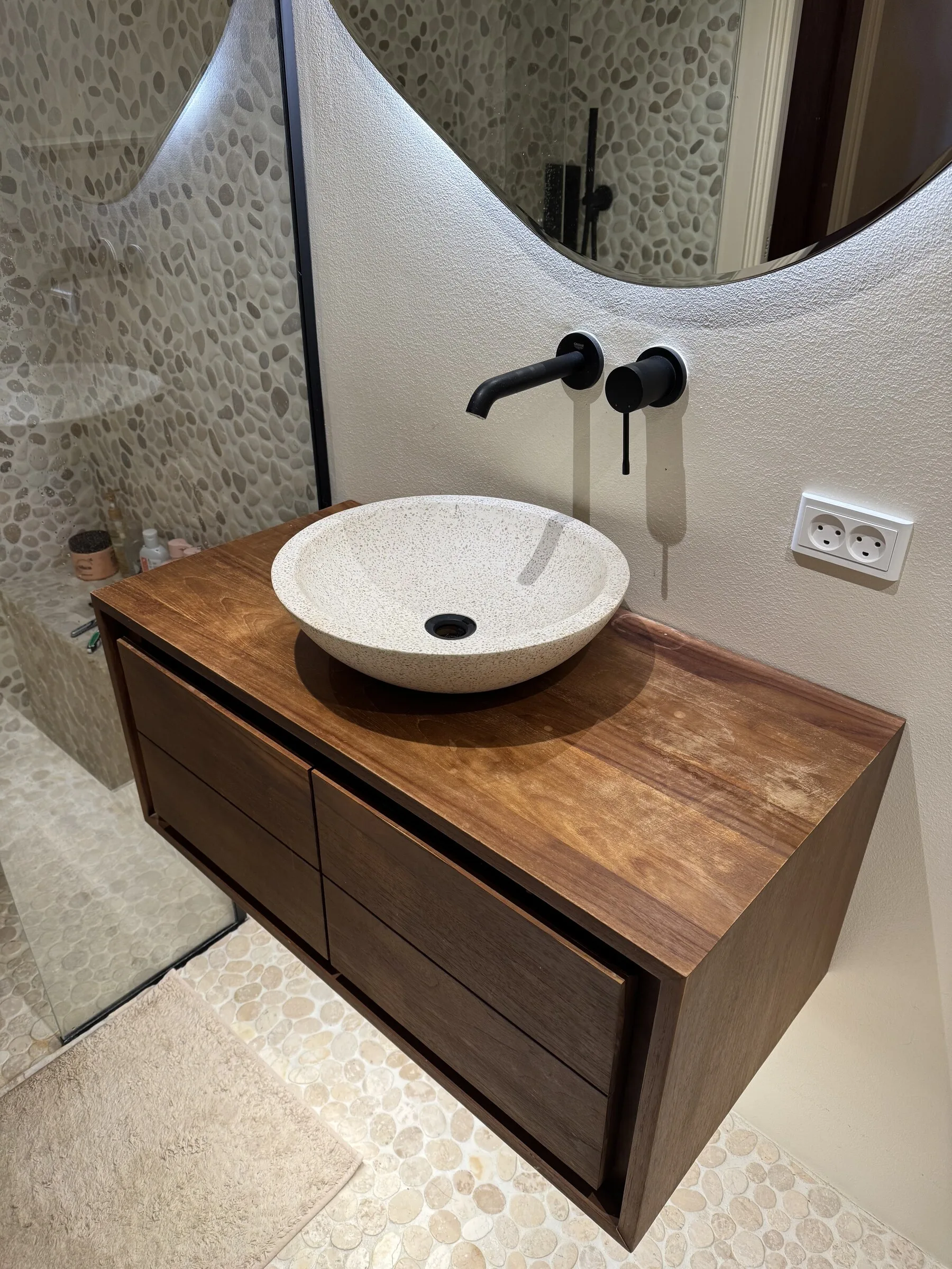 Bathroom vanity top before restoration, showing wear and a dull wood surface around the basin