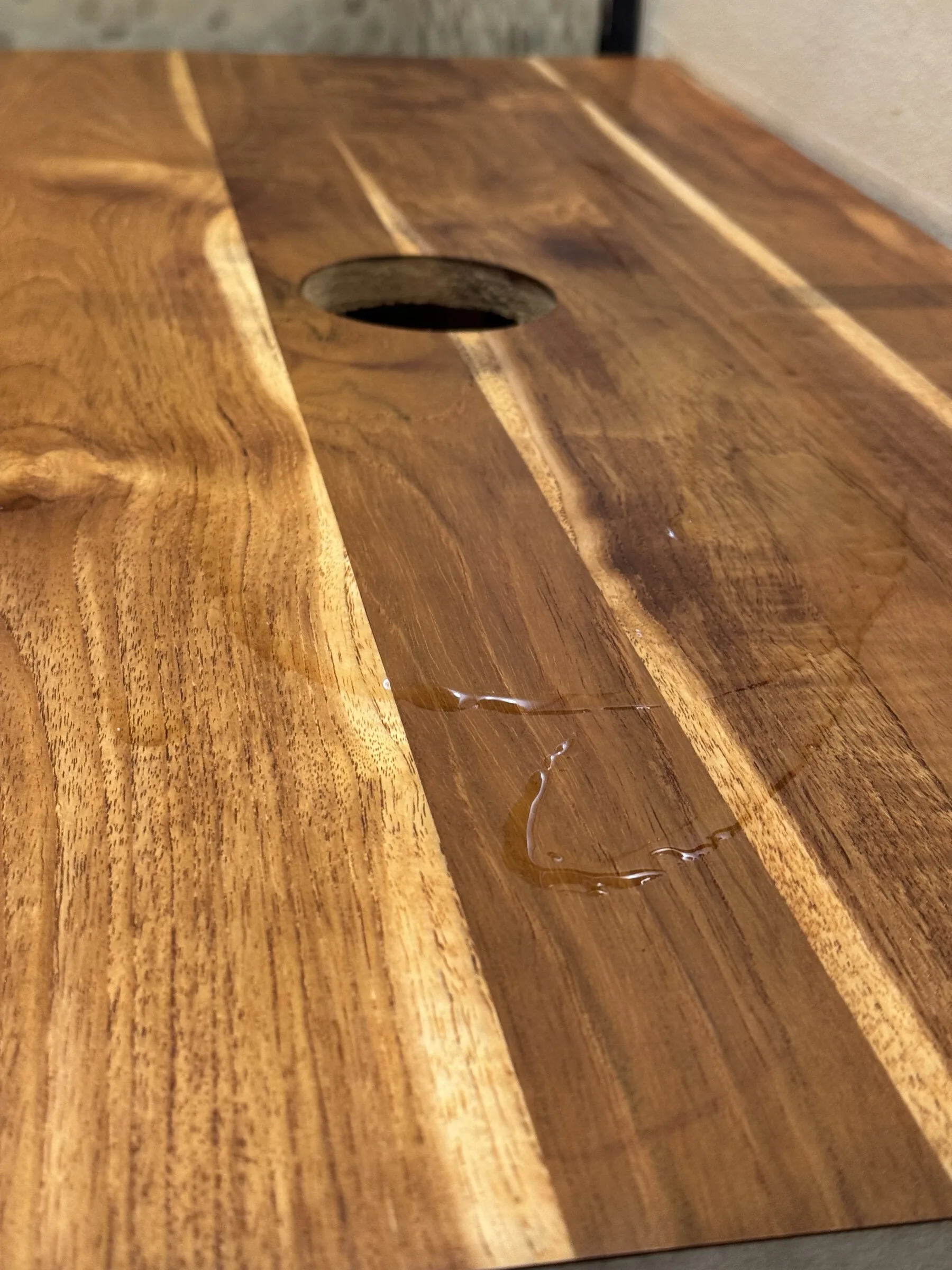Close detail of oil finish being worked into the restored bathroom vanity wood top