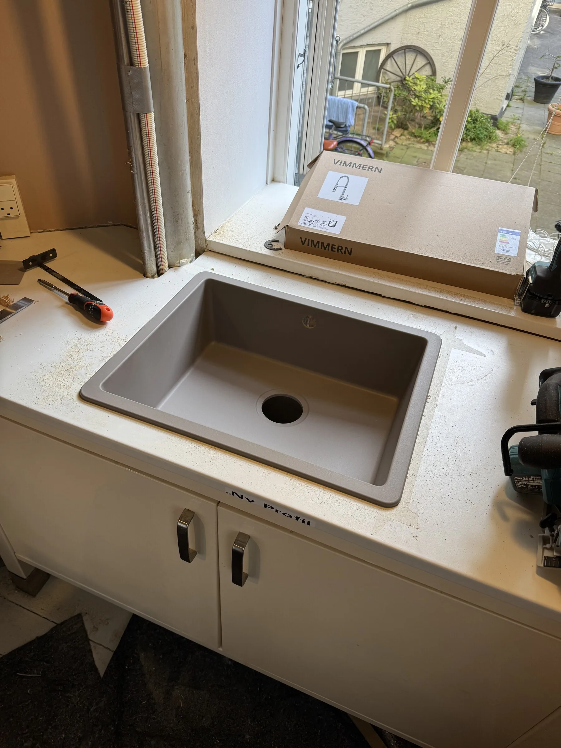 Newly fitted countertop with sink seated into place after replacement