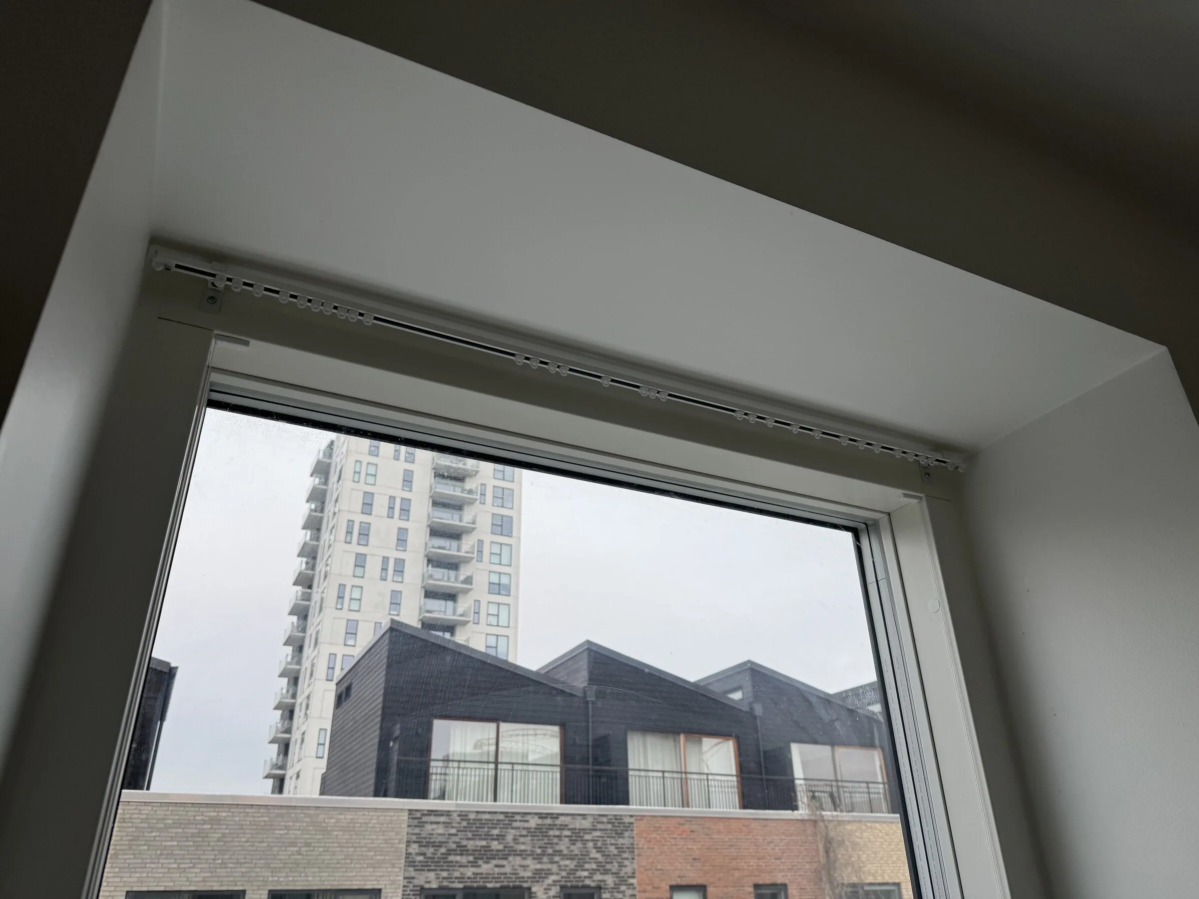 Window opening before curtain installation, with the track line visible above the frame