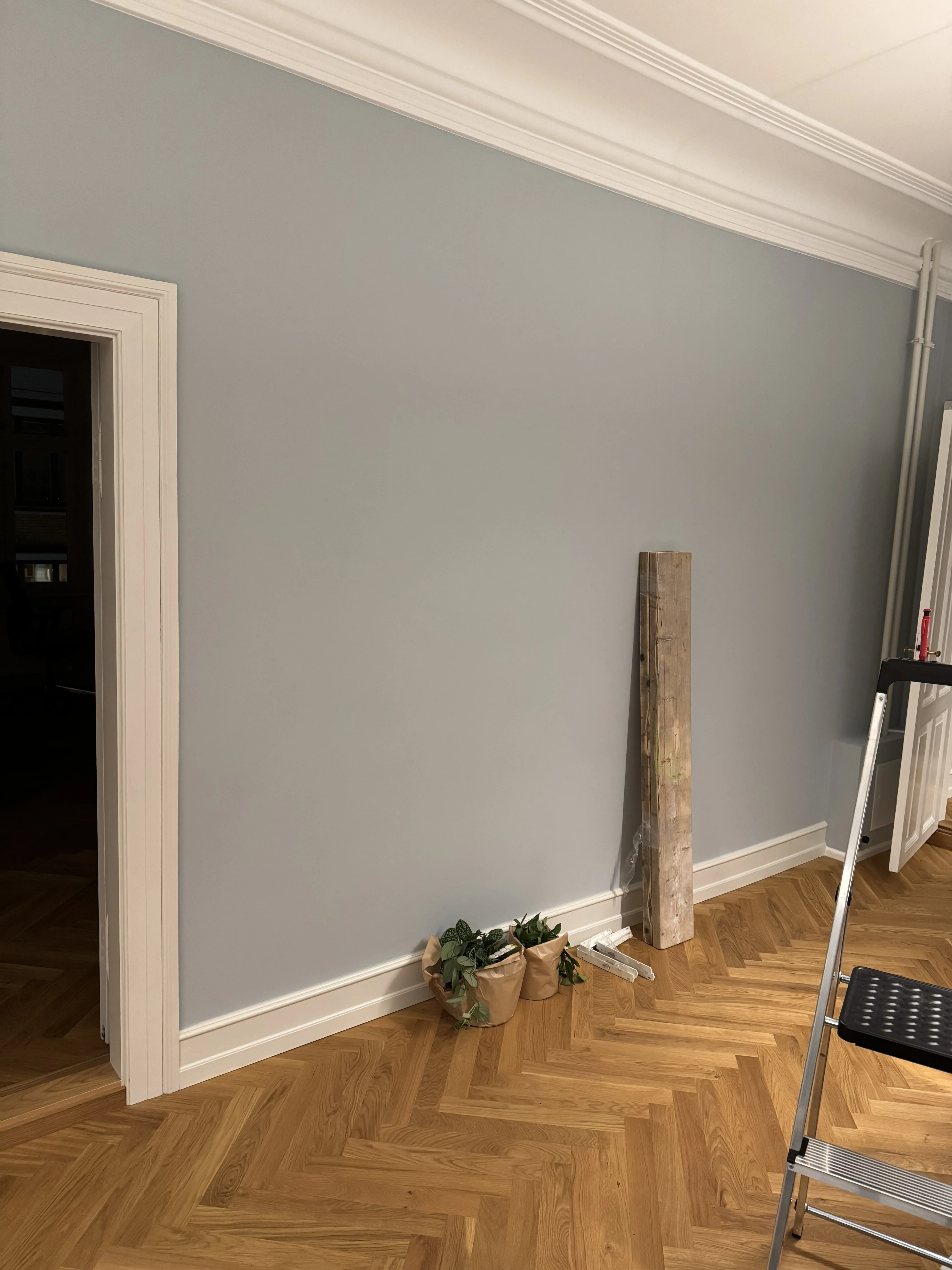 Wall prepared for two wood shelves before installation in a Copenhagen apartment