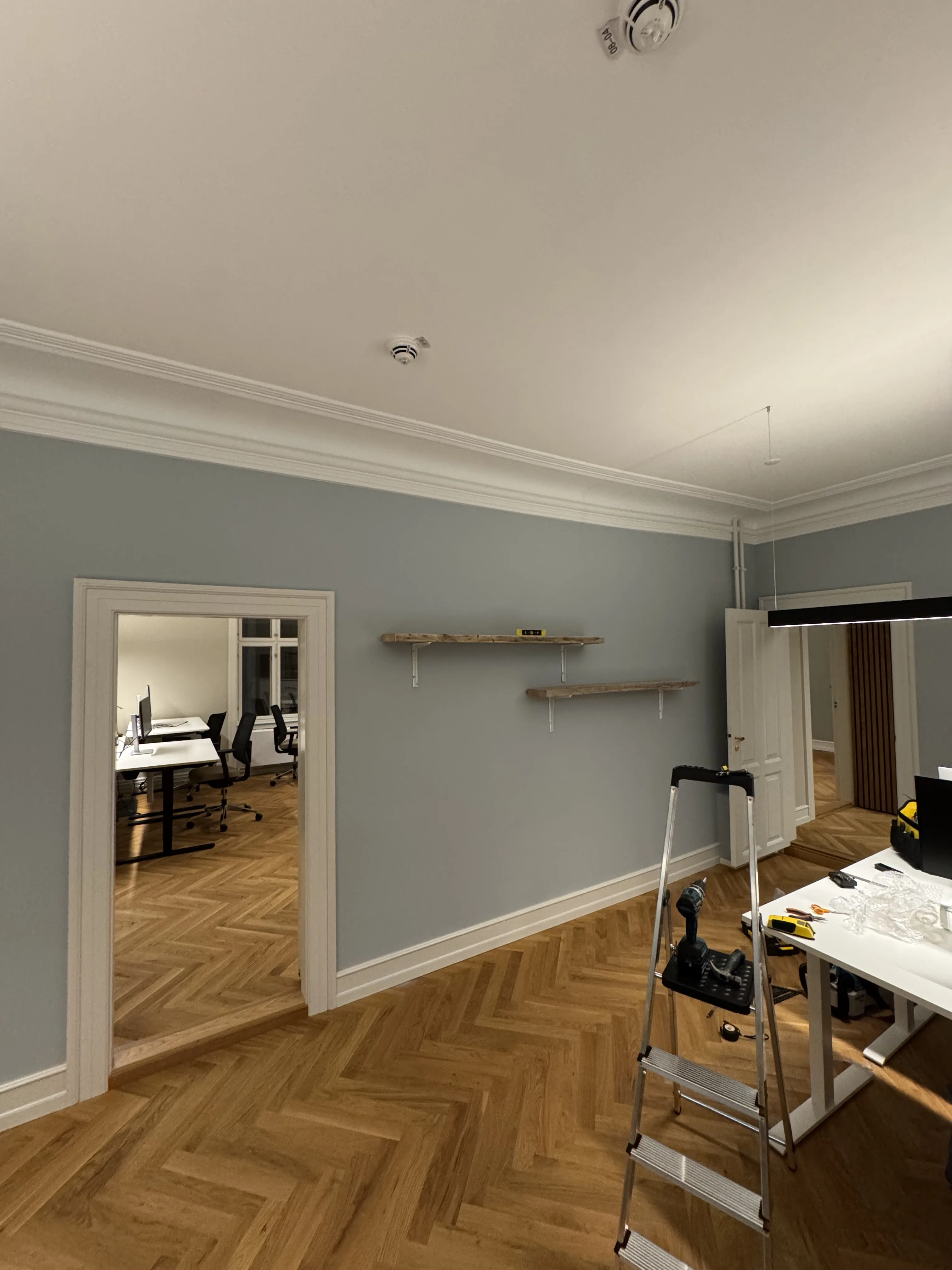 Two installed shelves being checked in the room while tools are still in place