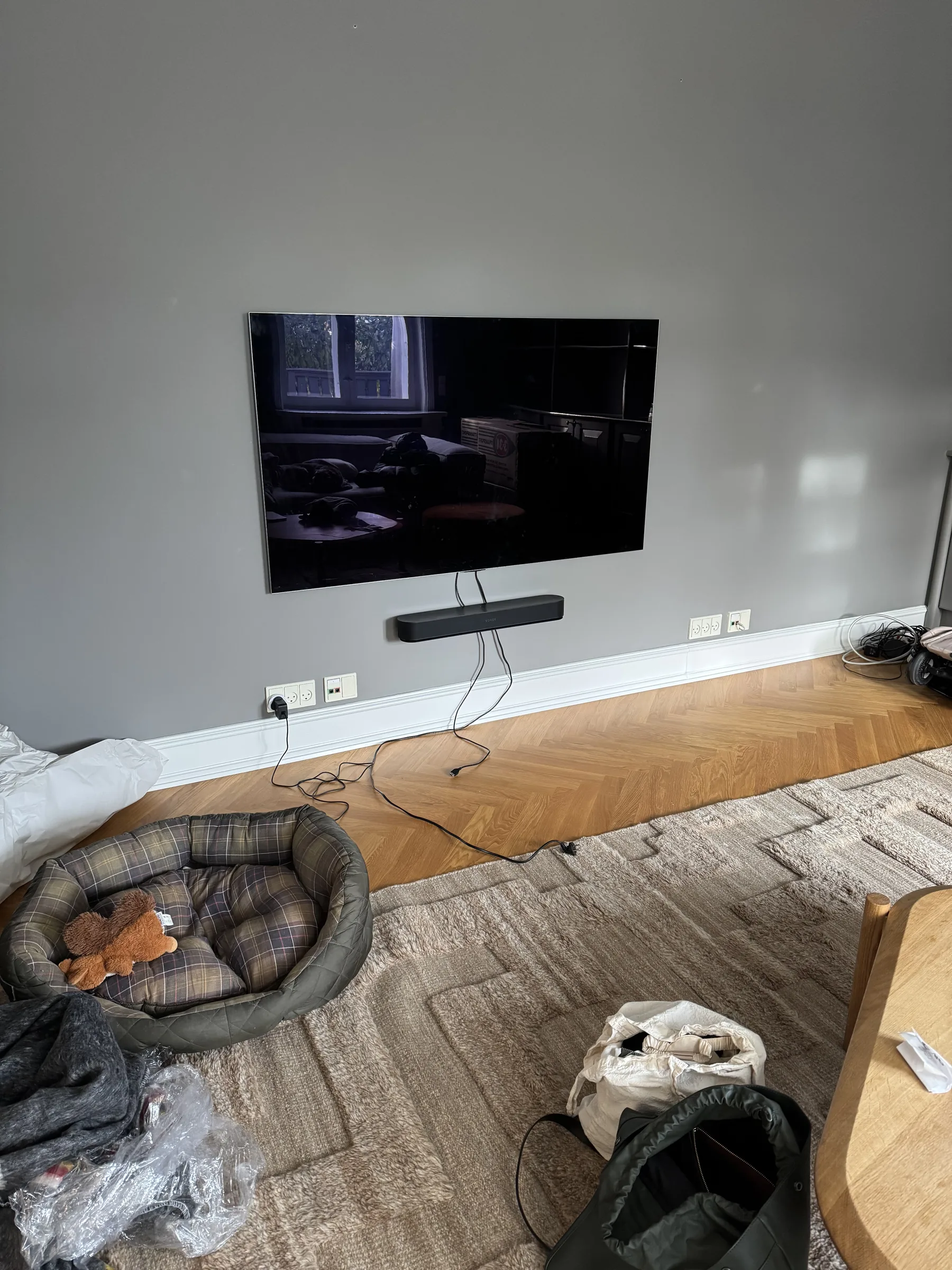 Finished wall-mounted TV above a low media area in a Copenhagen apartment