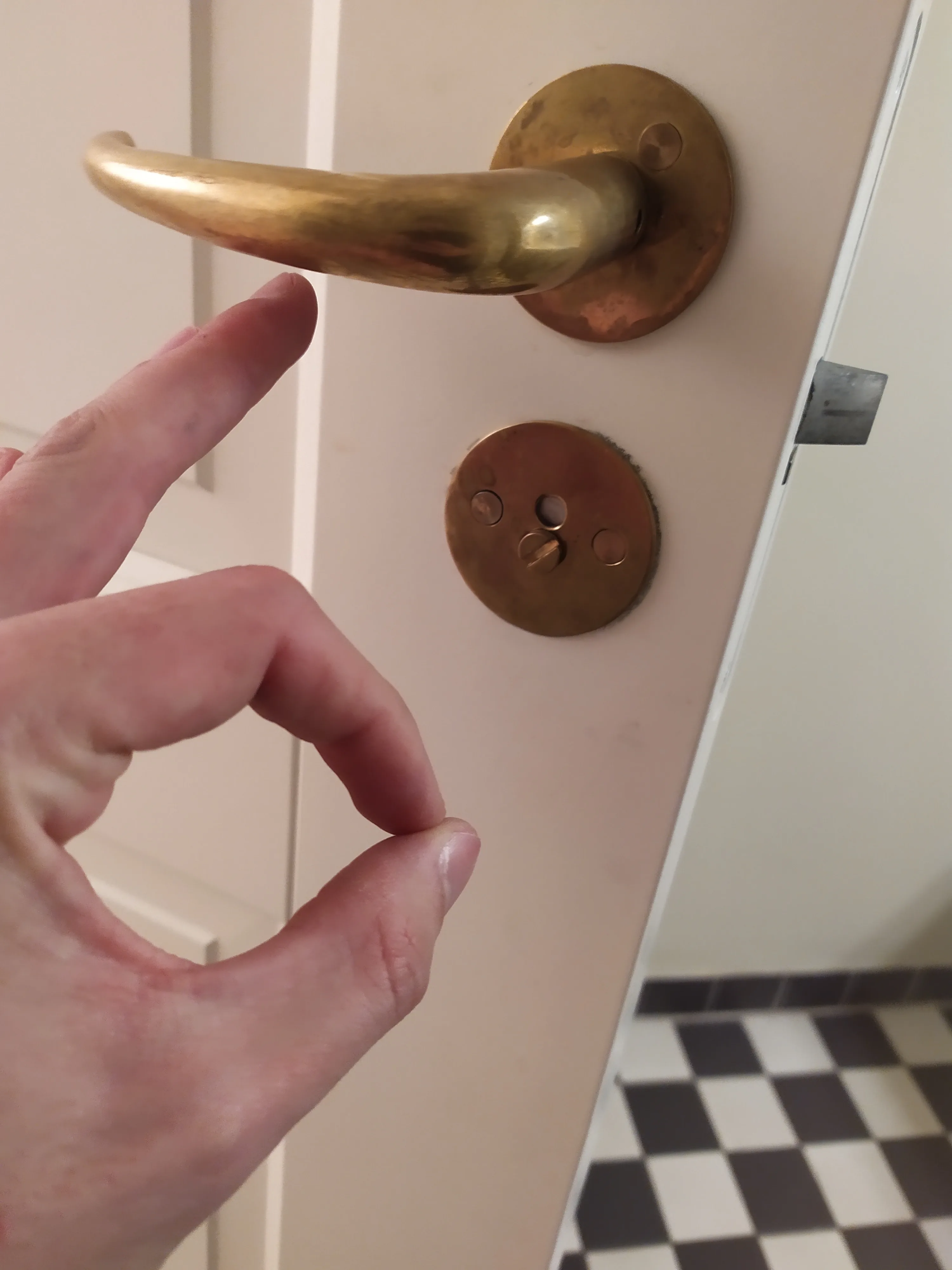Door lock hardware checked during rental apartment maintenance in Copenhagen